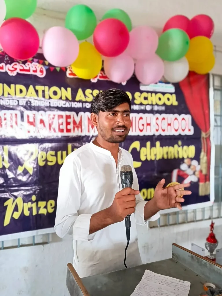 Teacher addressing students at the Annual Result Day and Prize Distribution