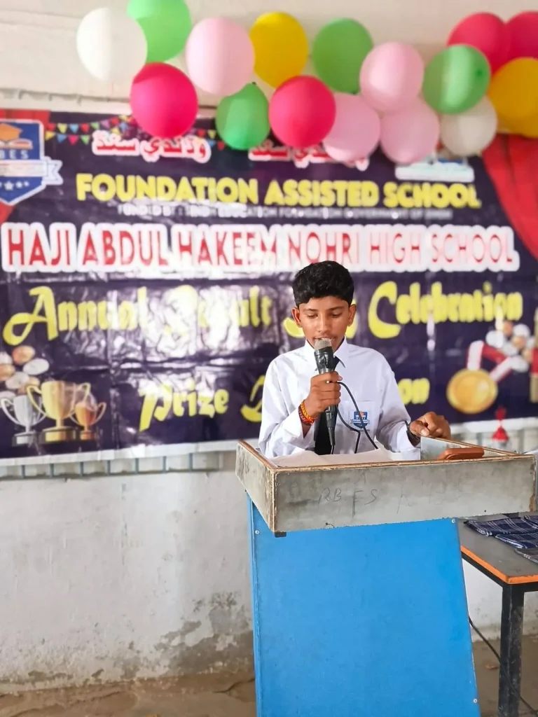 Student speaking at the podium at the result day celebration