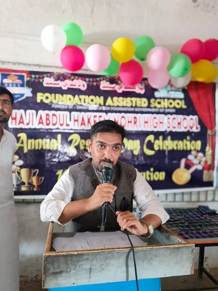 Teacher speaking at the podium during the ceremony