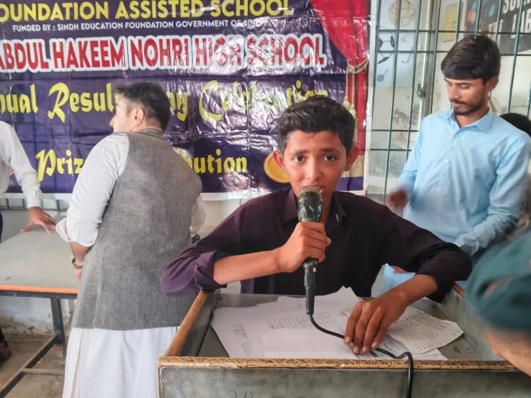 Student speaking into the microphone at the ceremony