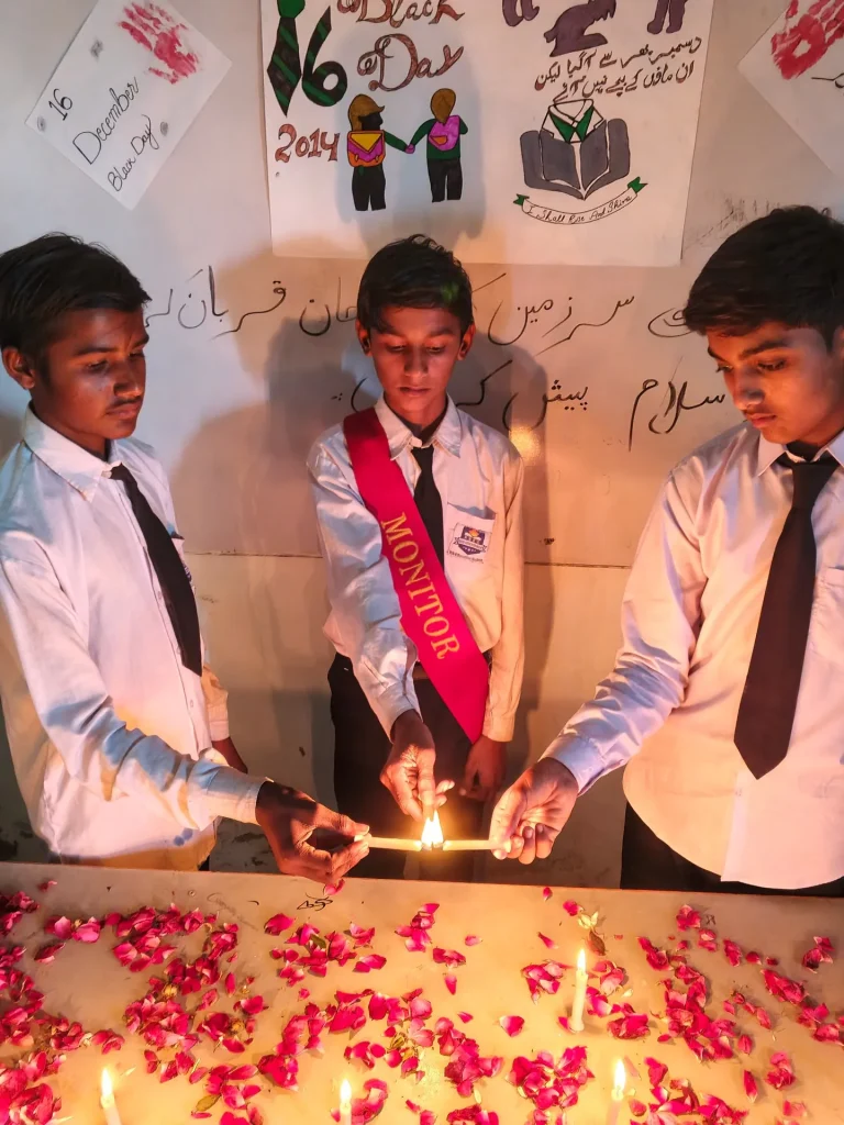 Student monitor lighting candles with classmates on 16 December