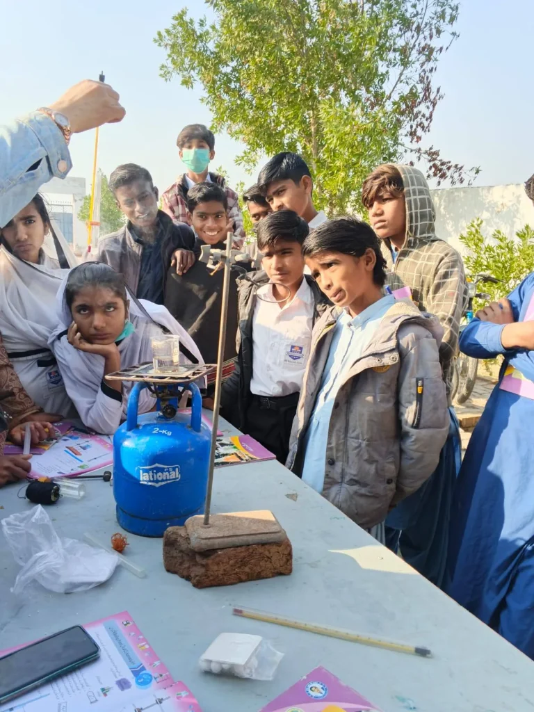 Students watching the heating apparatus during the practical