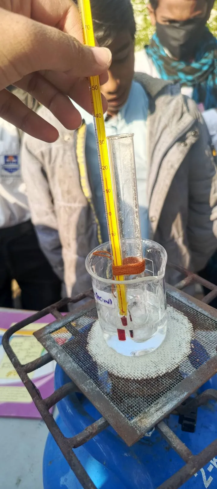 Test tube held in a beaker of water during the experiment