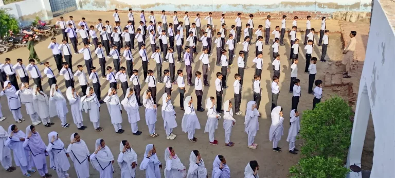 Girls and boys of RB Education System standing in disciplined rows during morning assembly